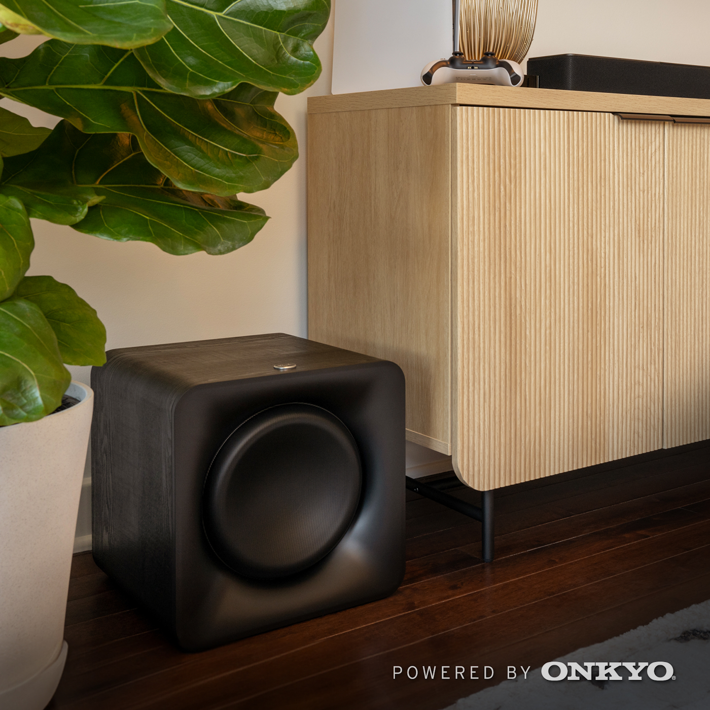 Klipsch Flexus SUB 100 beside fiddle leaf fig 2000x2000 logo v02