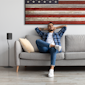 Klipsch Flexus SURR 100 beside relaxing guy 2000x2000